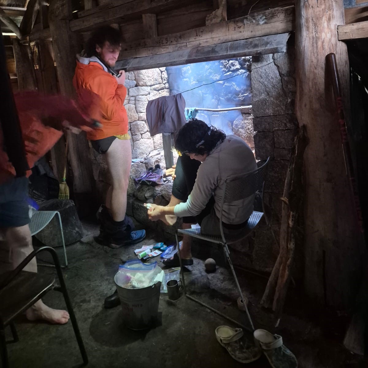 Crew and runners recuperating in tin mine hut